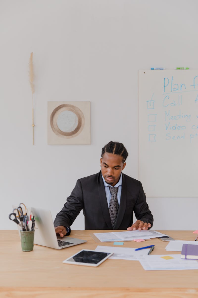 Mid-career manager reviewing work in an office meeting.